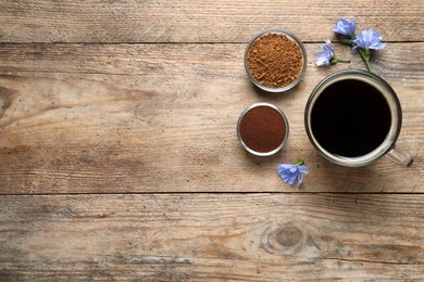 Photo of Cup of delicious chicory drink, flowers, granules and powder on wooden table, flat lay. Space for text