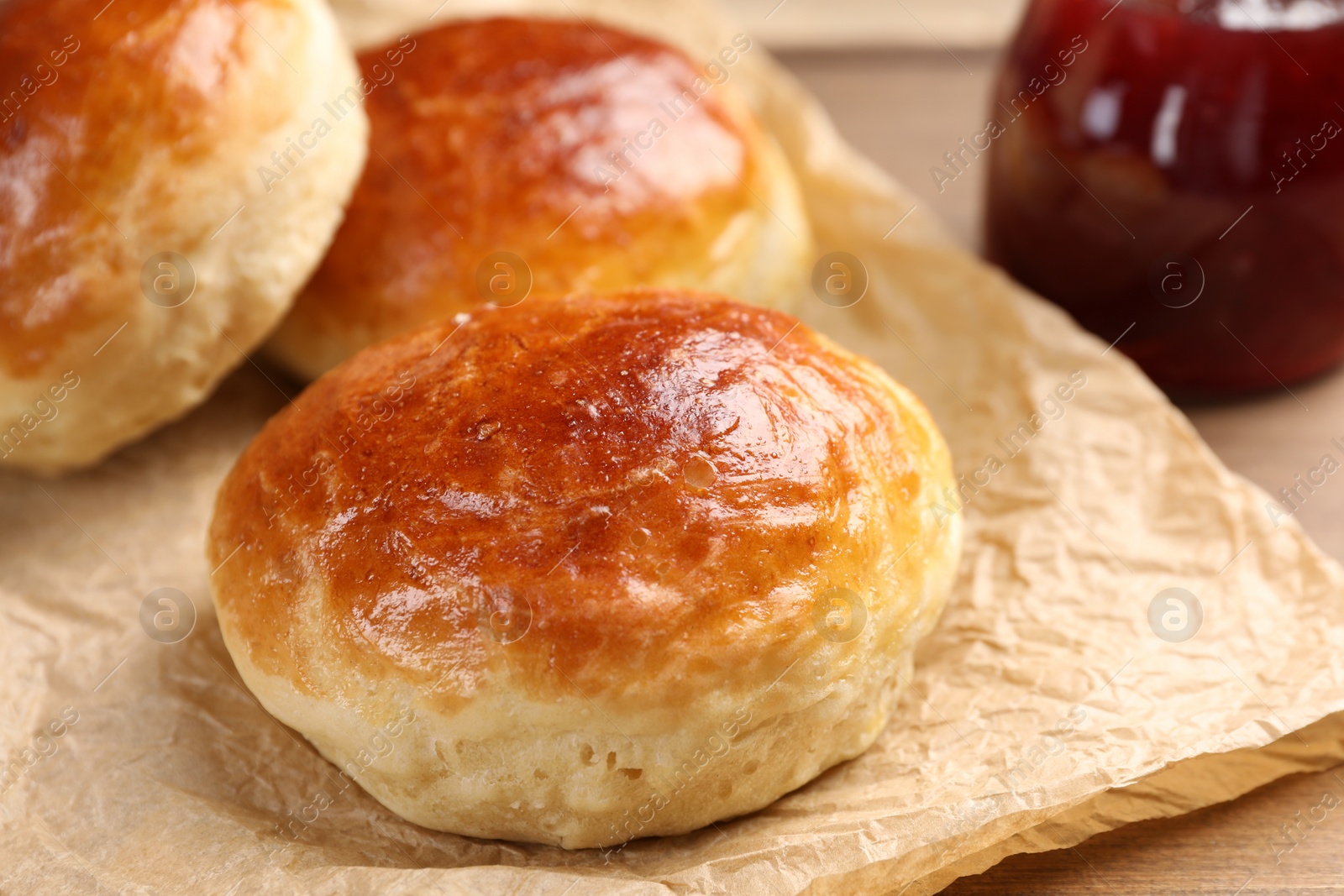 Photo of Tasty scones prepared on soda water and jam on wooden table, closeup