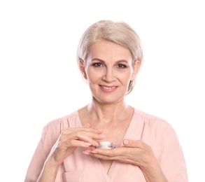 Mature woman with jar of anti-aging face cream on white background