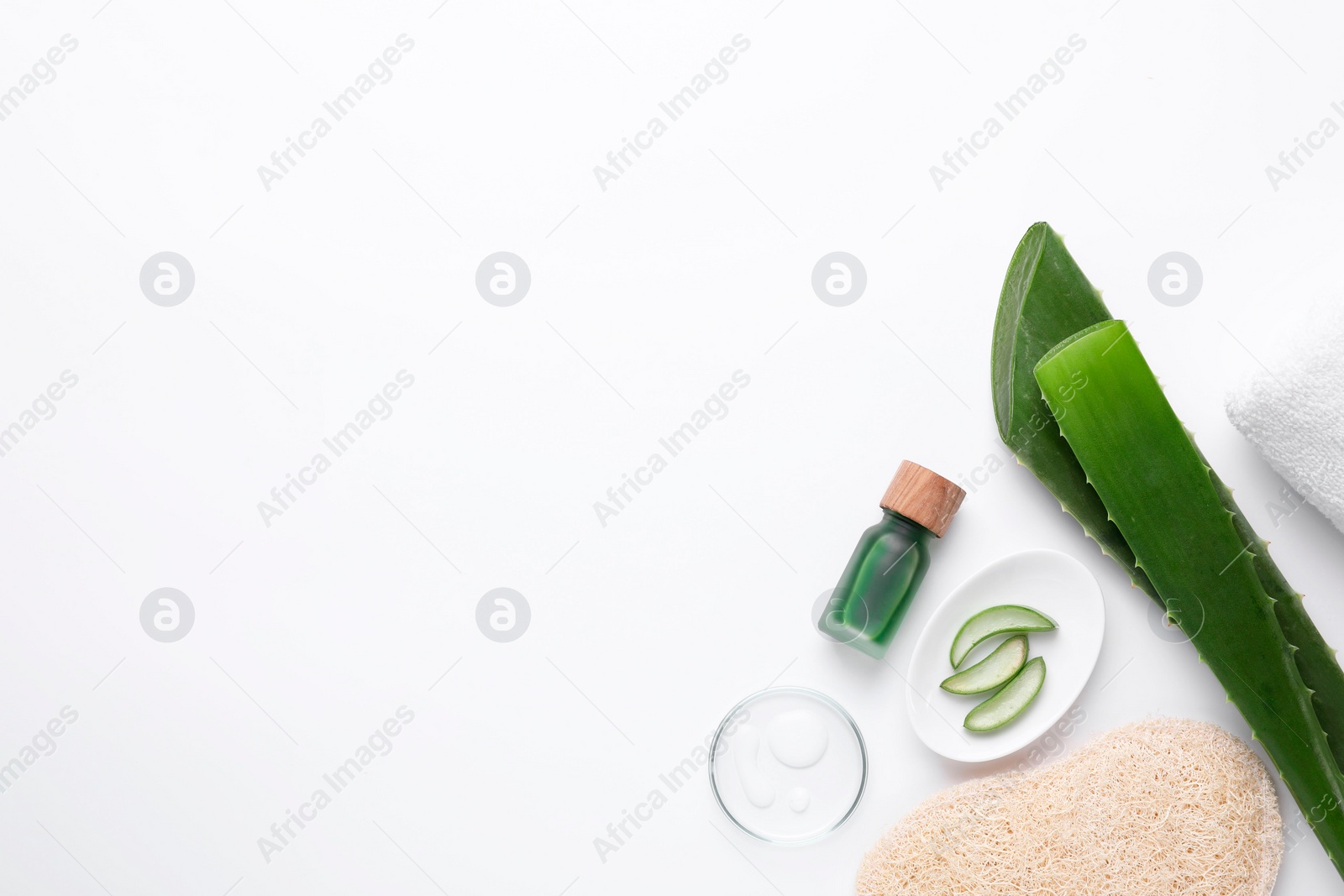 Photo of Cosmetic products and cut aloe leaves on white background, flat lay. Space for text