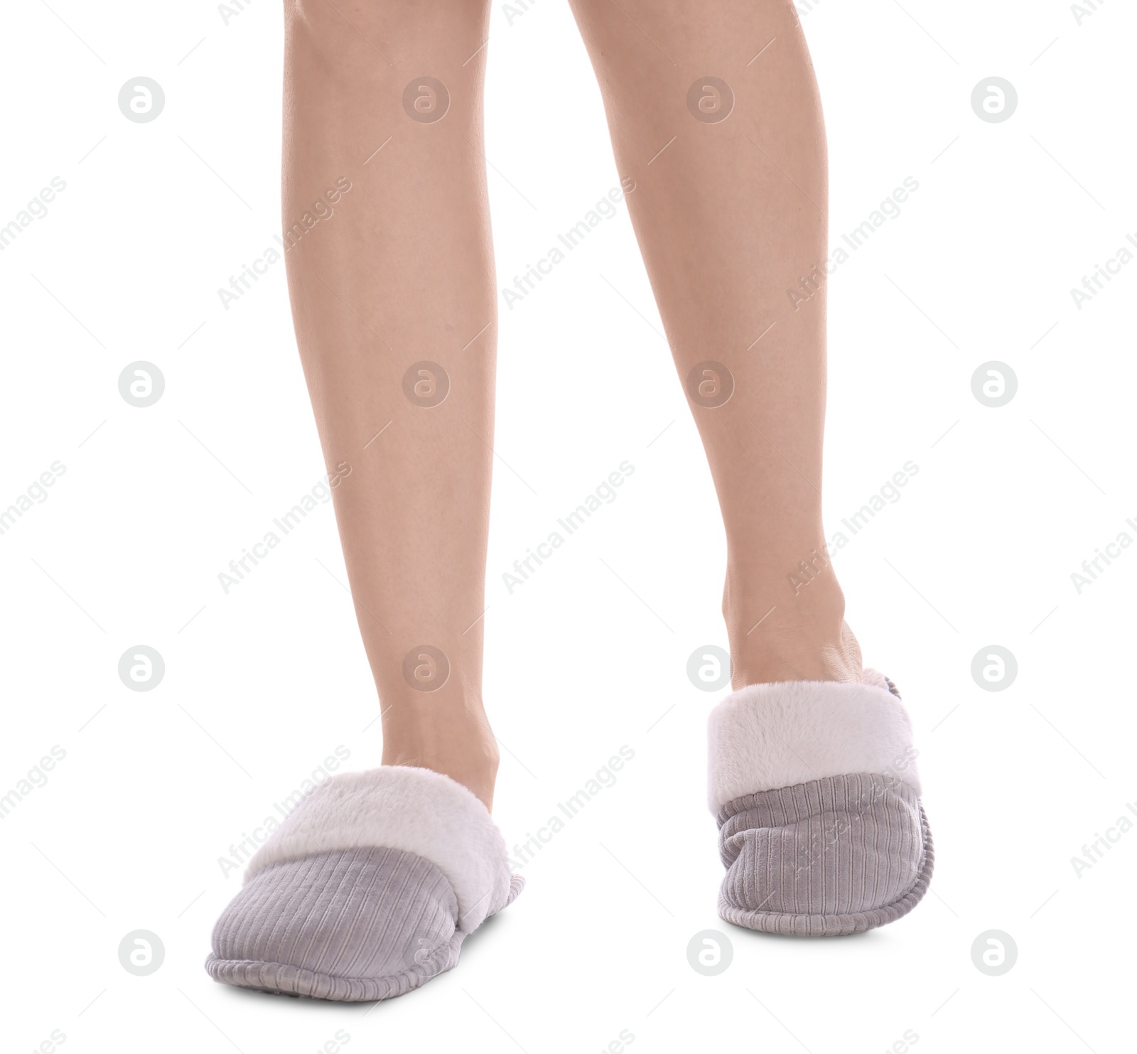 Photo of Woman in warm soft slippers on white background, closeup