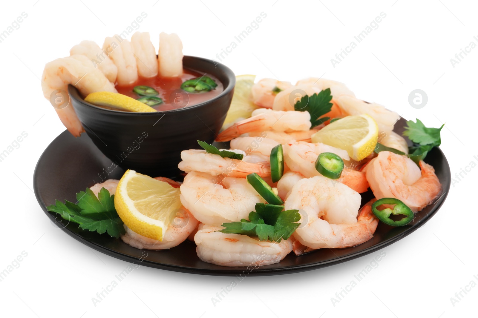 Photo of Tasty boiled shrimps with cocktail sauce, chili, parsley and lemon isolated on white