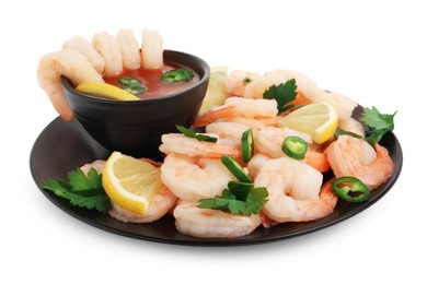 Tasty boiled shrimps with cocktail sauce, chili, parsley and lemon isolated on white