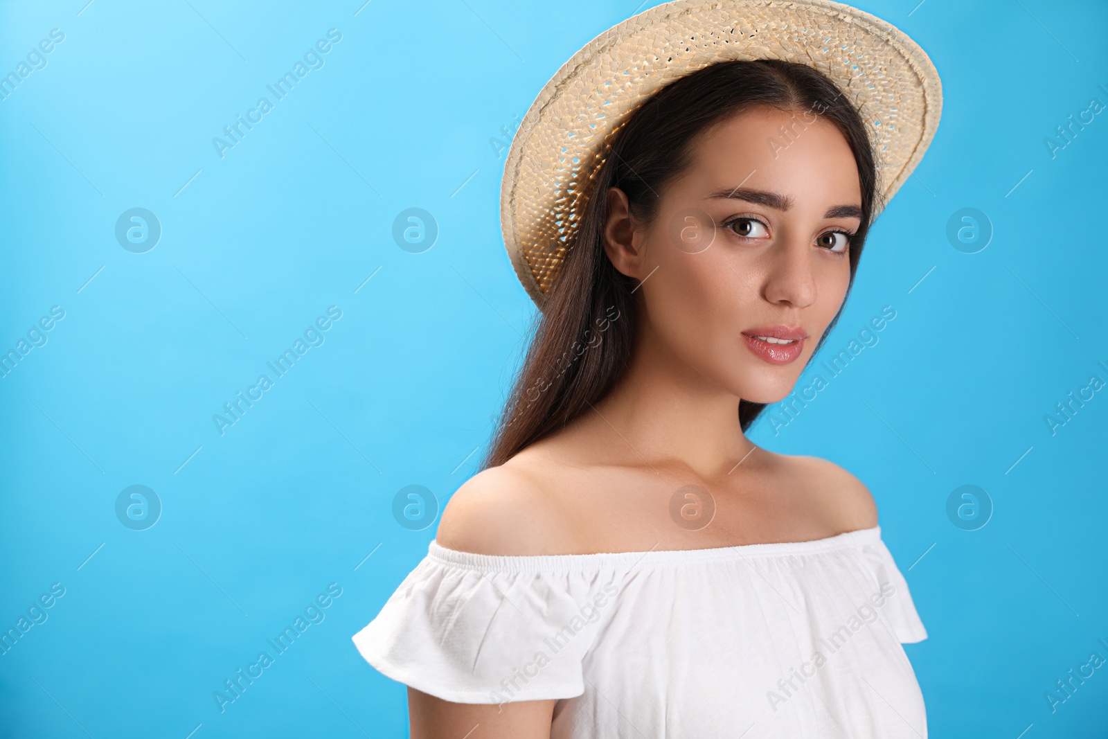 Photo of Portrait of beautiful young woman on light blue background