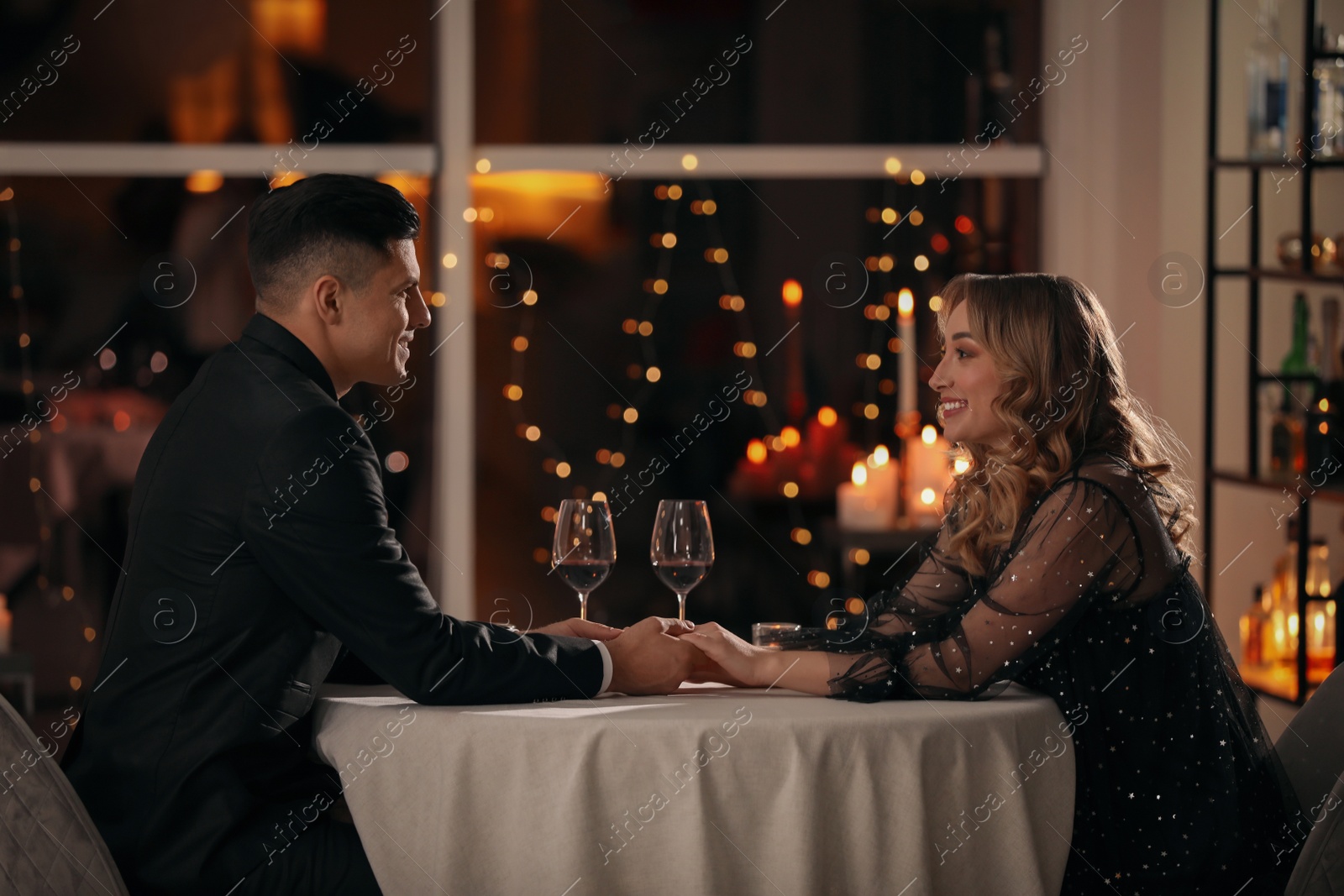 Photo of Lovely couple having romantic dinner on Valentine's day in restaurant