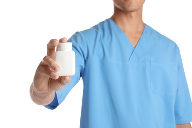 Male doctor holding pill bottle on white background, closeup with space for text. Medical object