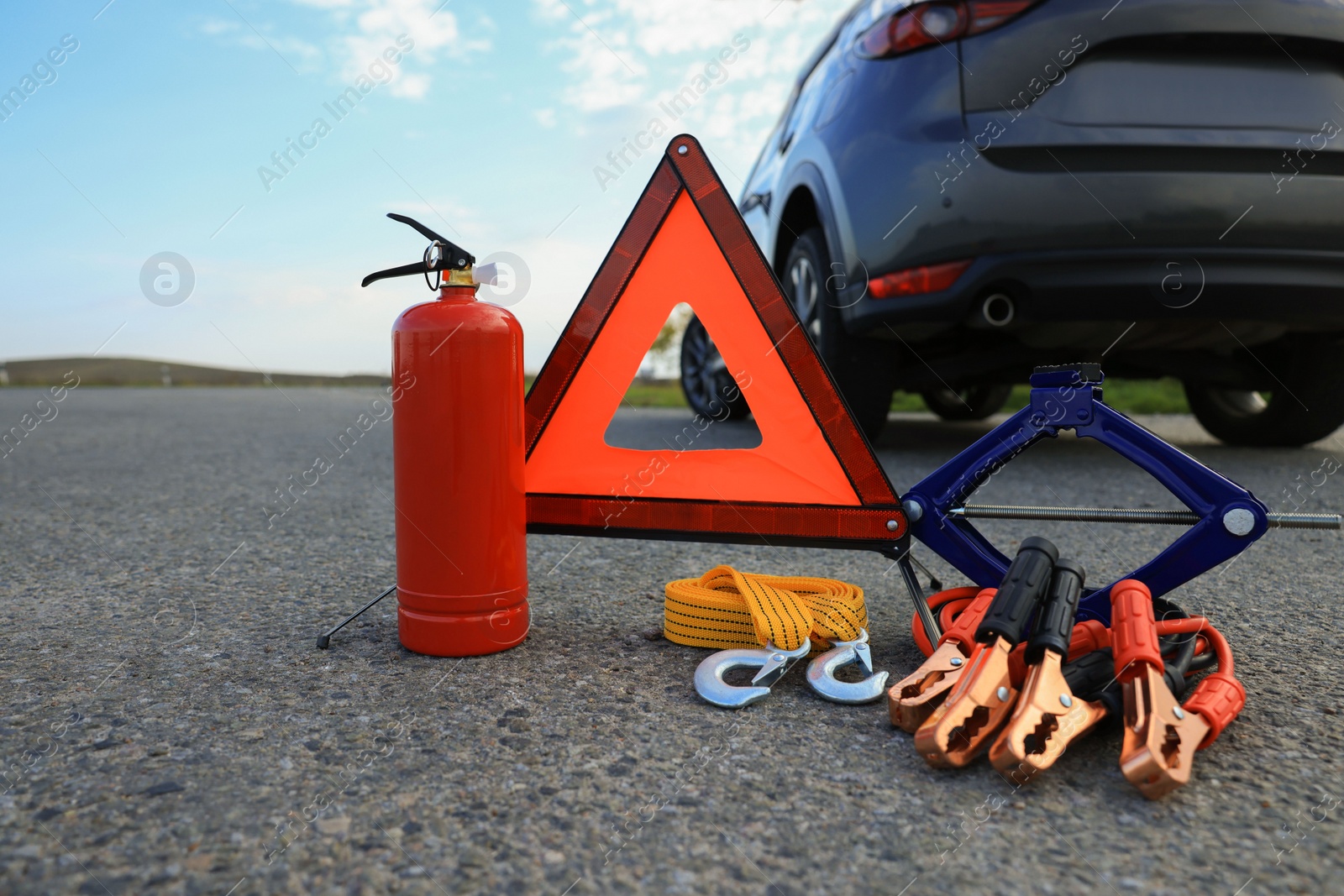 Photo of Emergency warning triangle and car safety equipment outdoors