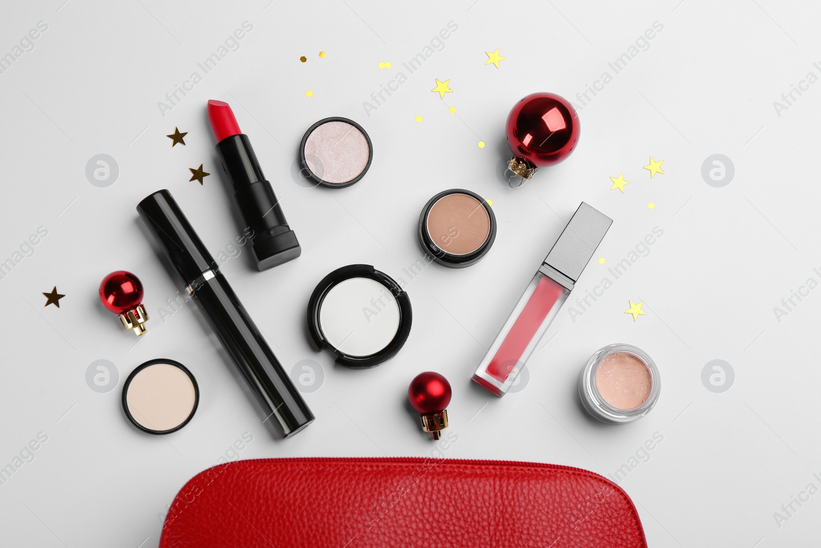 Photo of Flat lay composition with decorative cosmetic products and bag on light background. Winter care