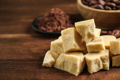 Organic cocoa butter on wooden table, closeup