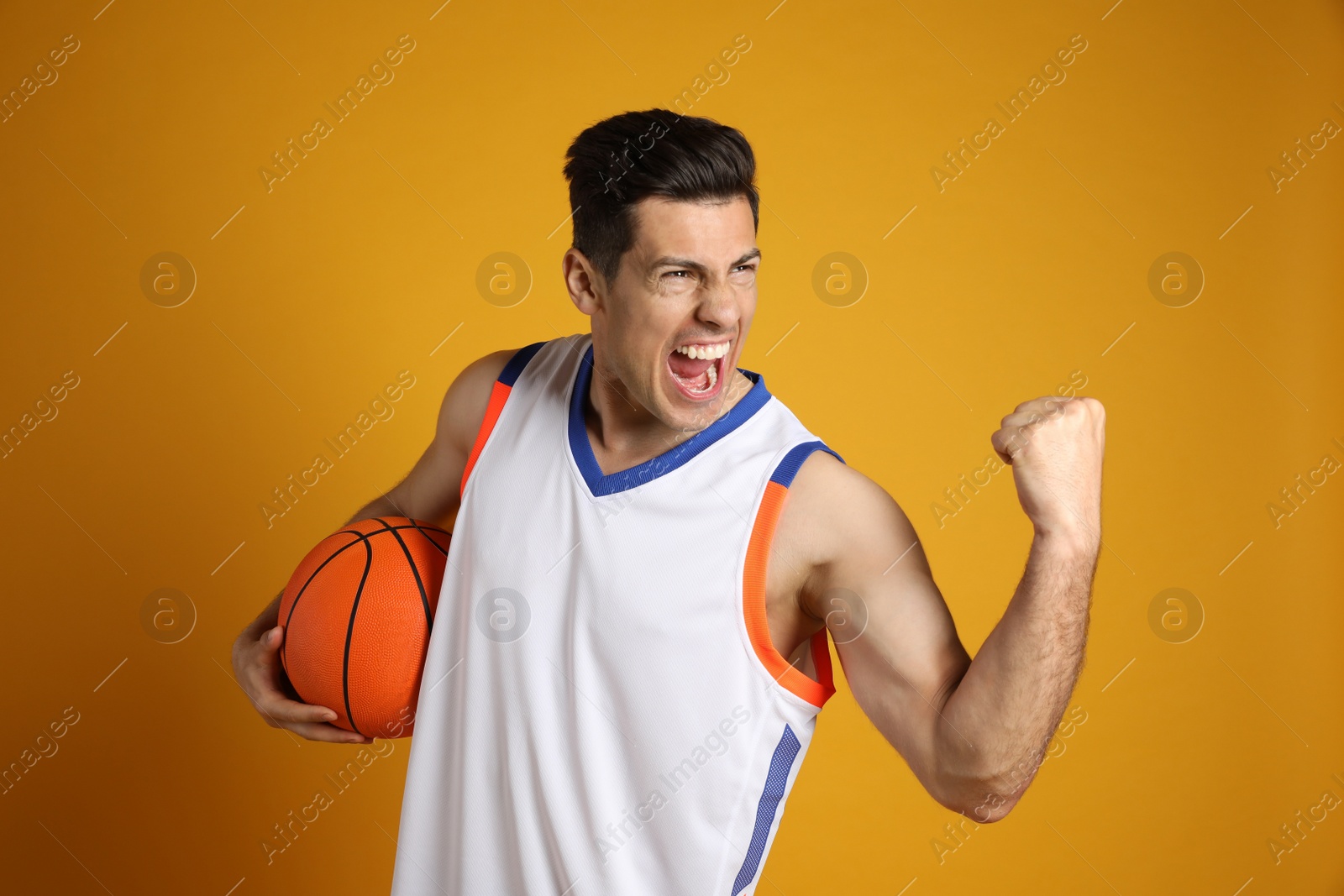 Photo of Basketball player with ball on yellow background