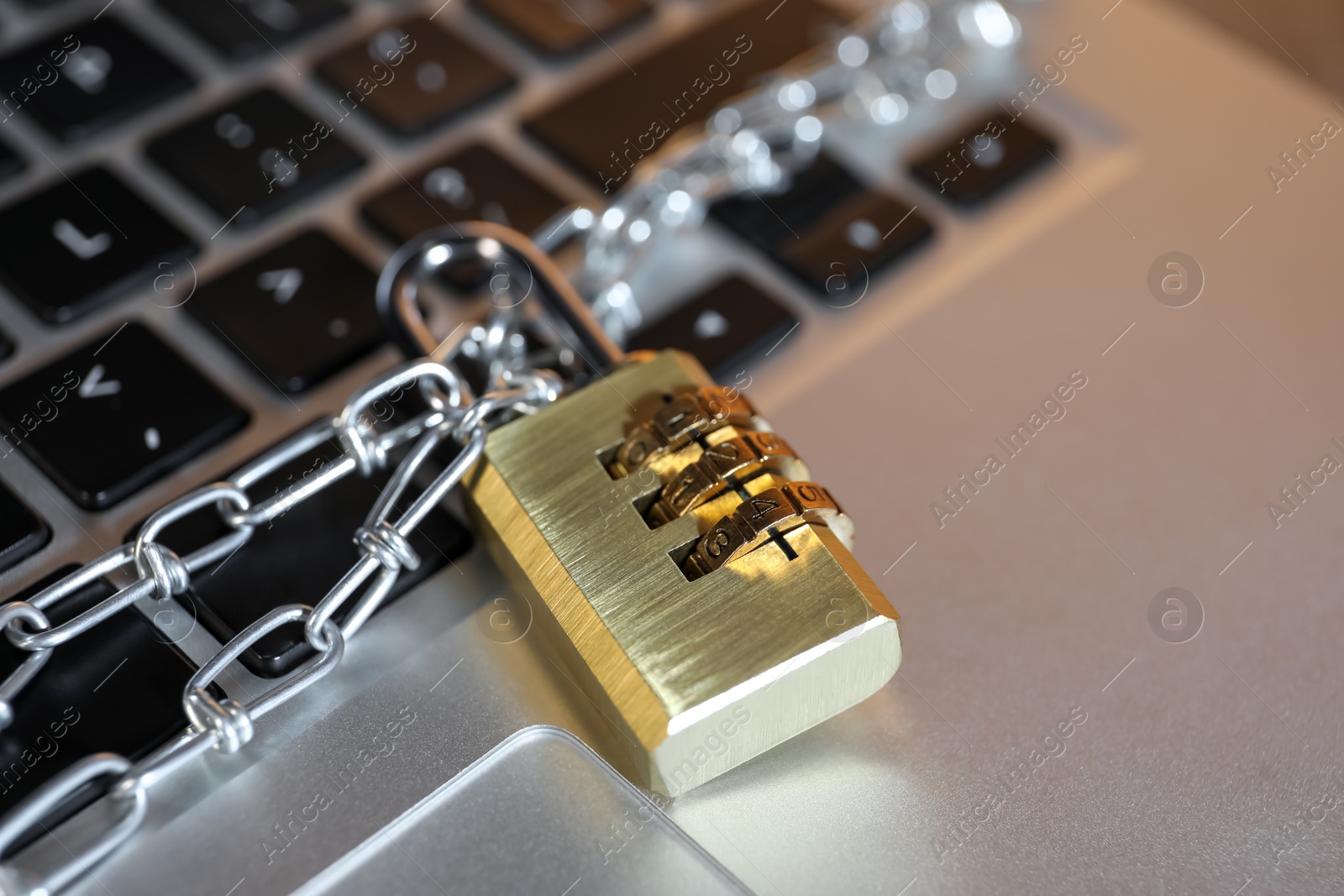 Photo of Cyber security. Padlock with chain on laptop, closeup