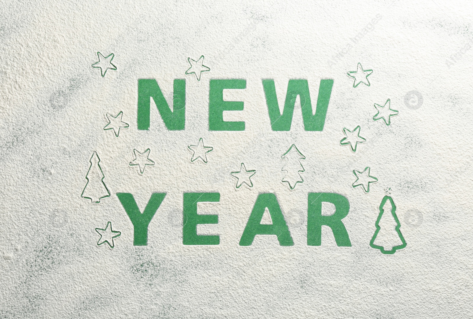 Photo of Words NEW YEAR made of flour on green background, top view