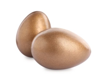 Photo of Two golden eggs on white background. Pension concept