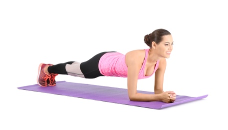 Young beautiful woman doing exercise on white background. Home fitness