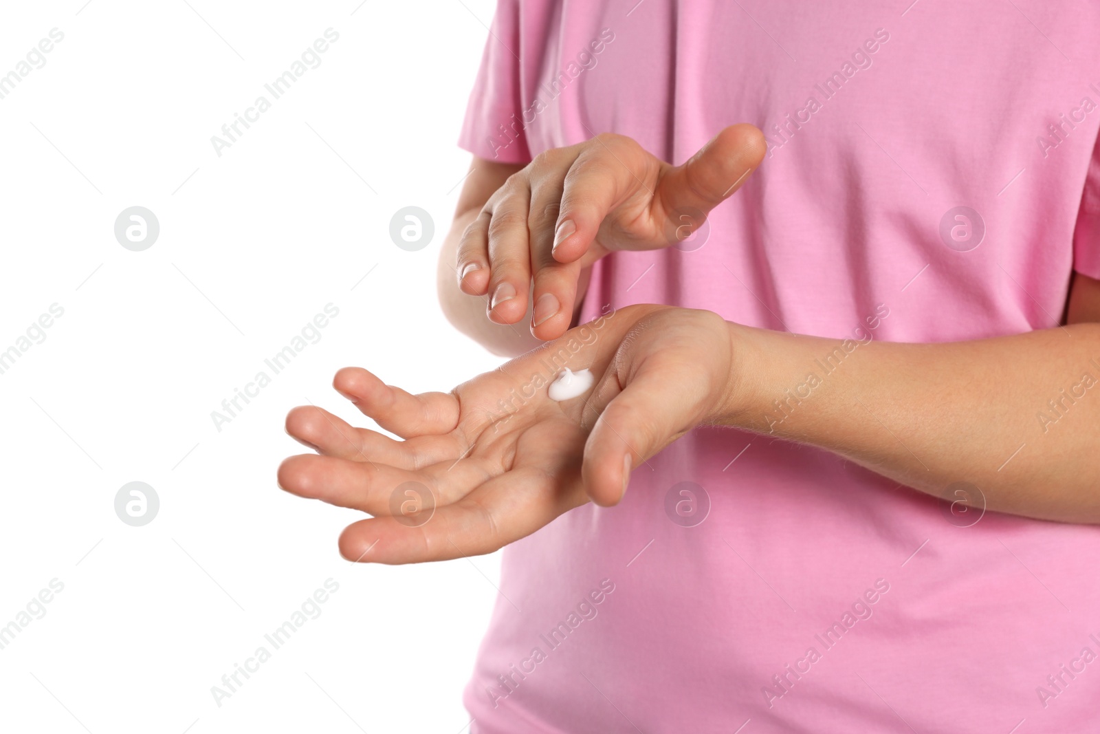 Photo of Woman applying cream on her hand against white background, closeup