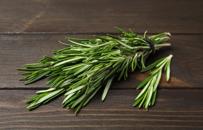 Bunch of fresh rosemary on wooden table