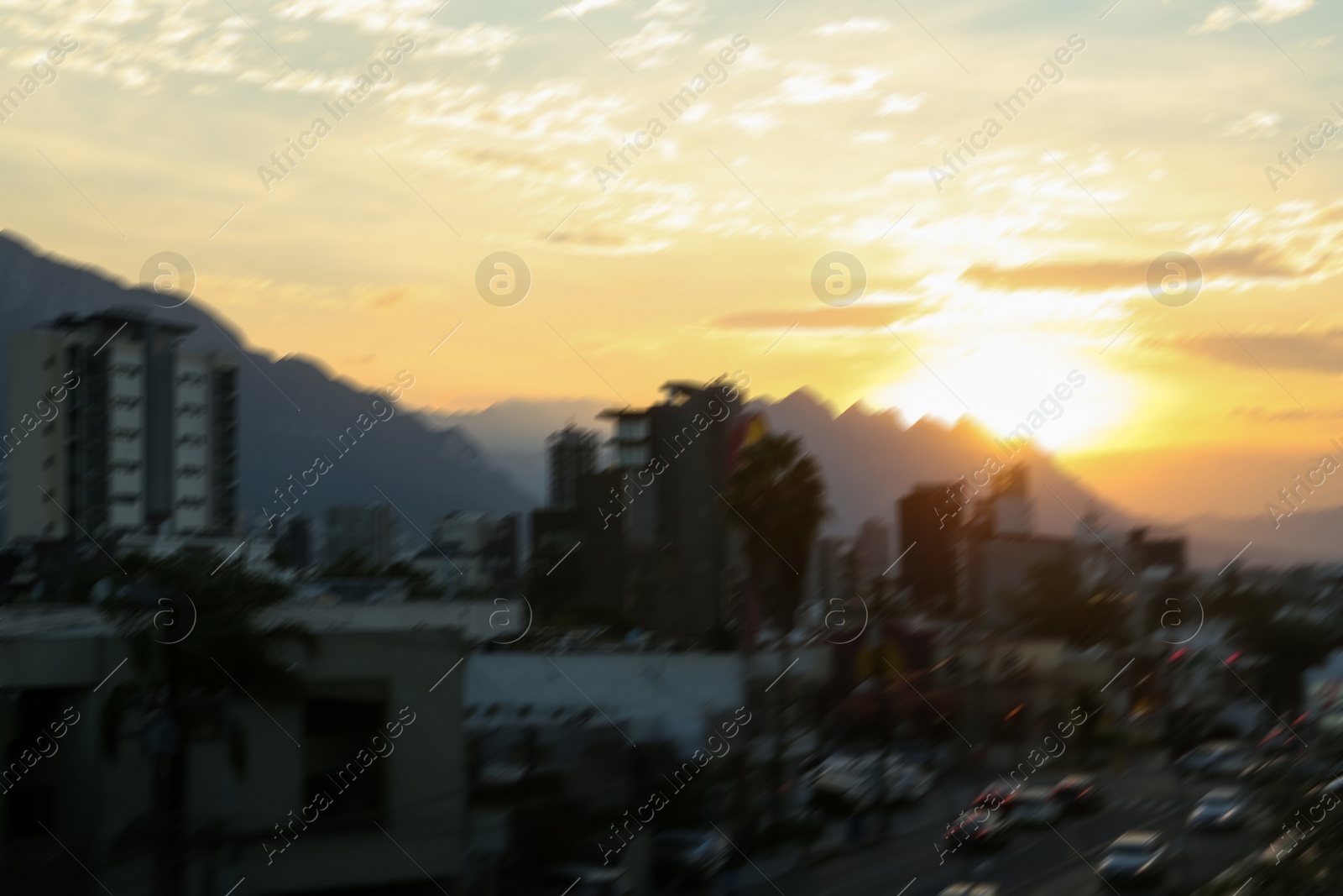 Photo of Picturesque view of city and mountains at sunset