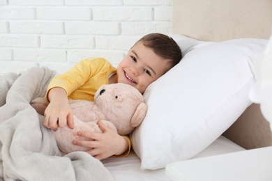 Photo of Cute child resting in bed at hospital