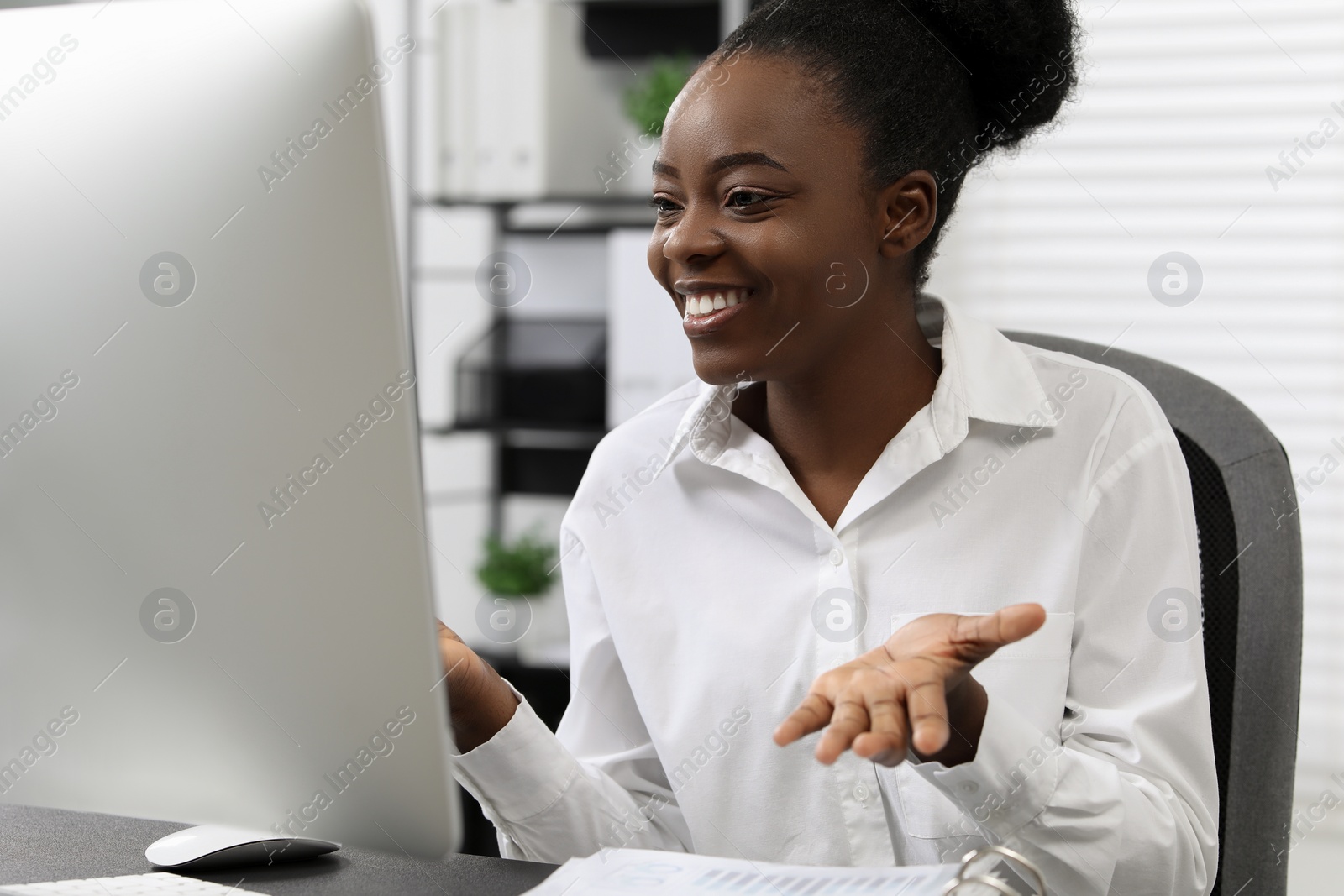 Photo of Professional accountant having video chat via computer at desk in office