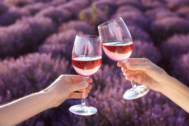 Photo of People with glasses of wine in lavender field