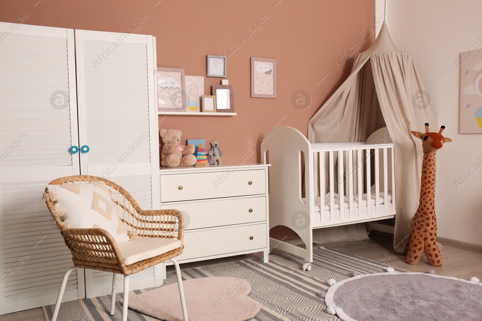 Photo of Baby room interior with stylish furniture and comfortable crib