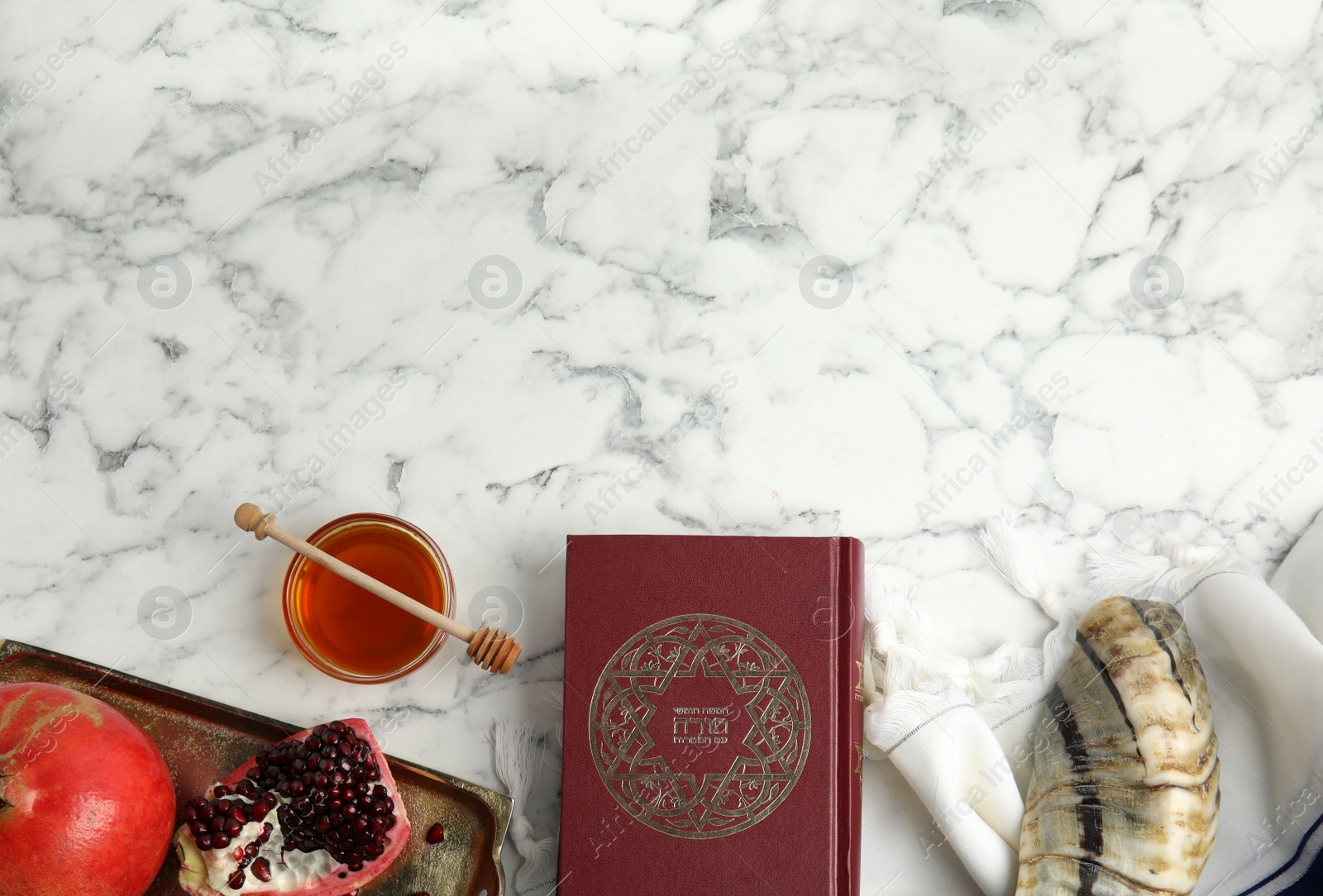 Photo of Flat lay composition with Rosh Hashanah holiday symbols on white marble table. Space for text