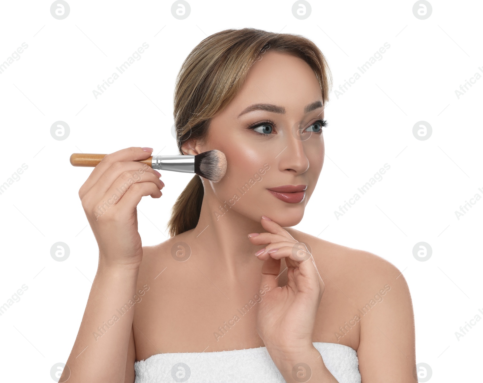 Photo of Beautiful young woman applying face powder with brush on white background