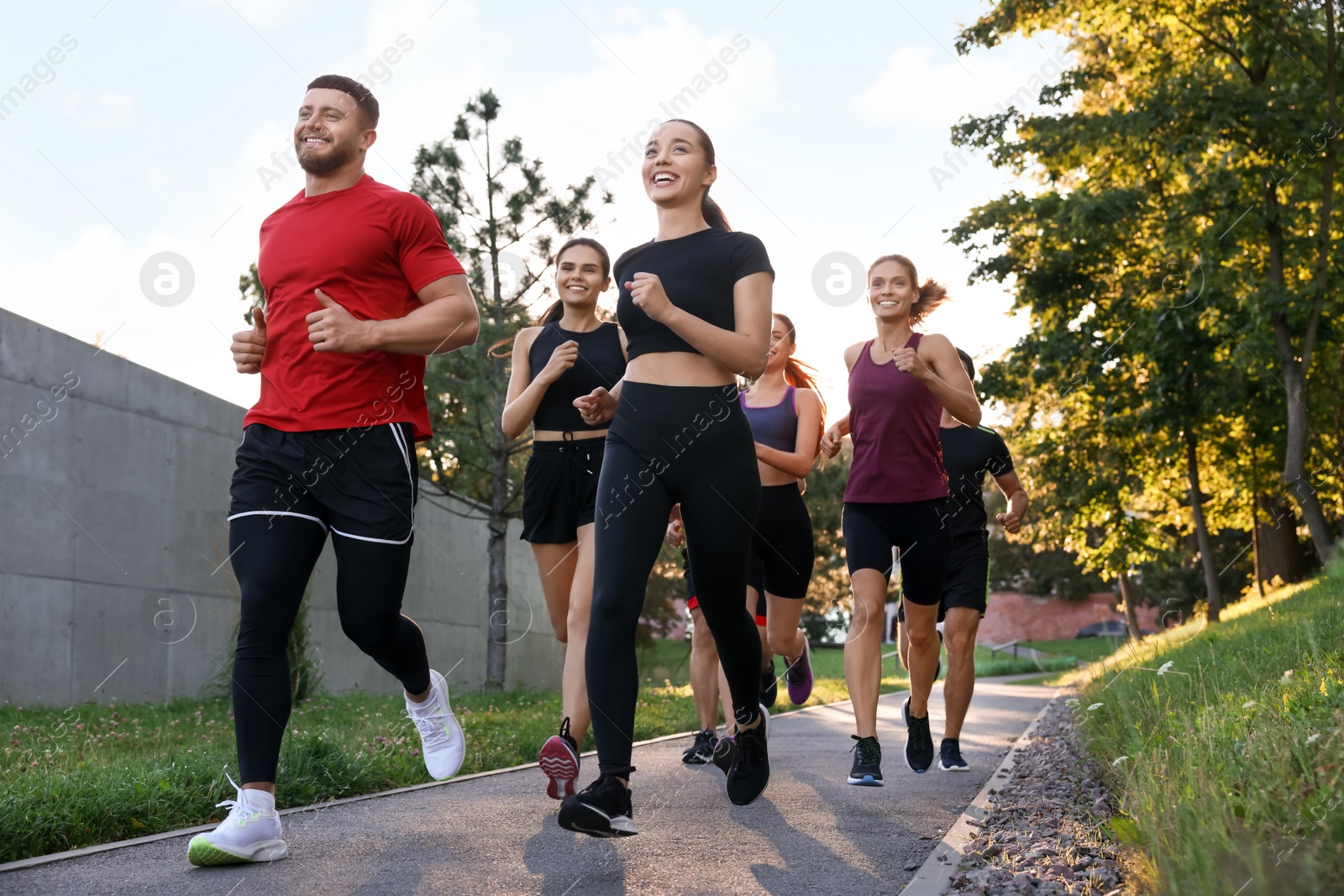 Photo of Group of people running outdoors. Active lifestyle