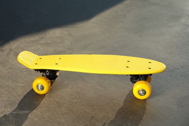 Photo of Modern yellow skate board outdoors. Sport equipment