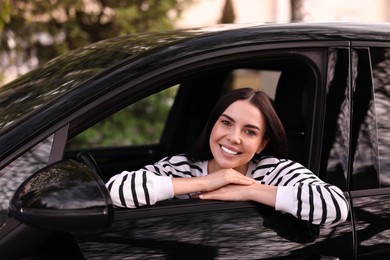 Young woman sitting inside her modern car