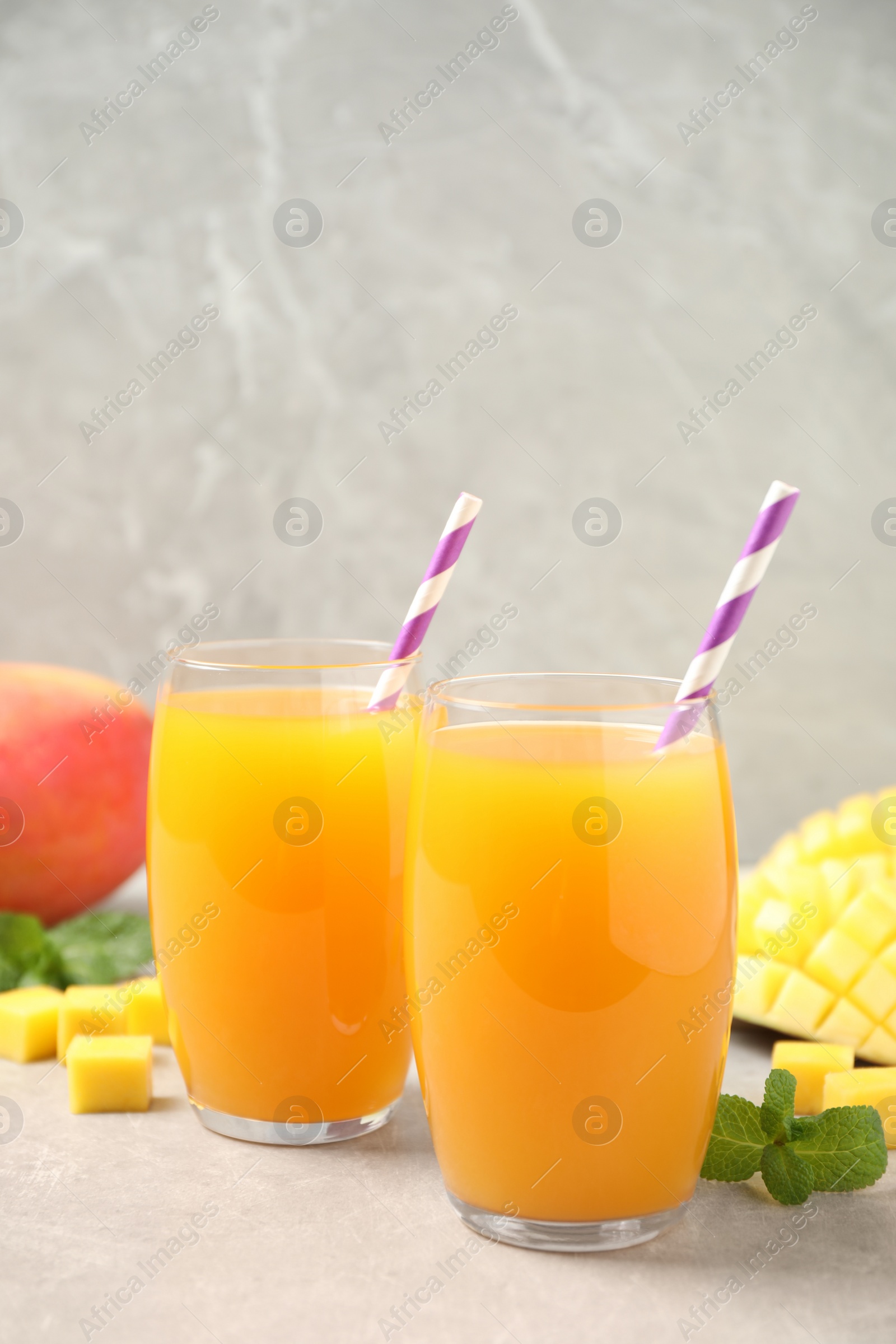 Photo of Fresh delicious mango drink on light table