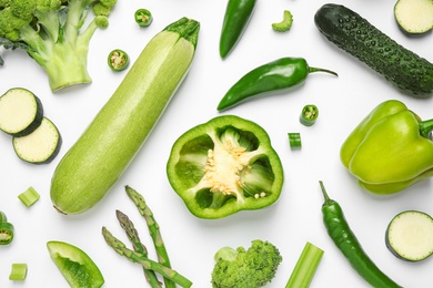 Flat lay composition with fresh vegetables on white background