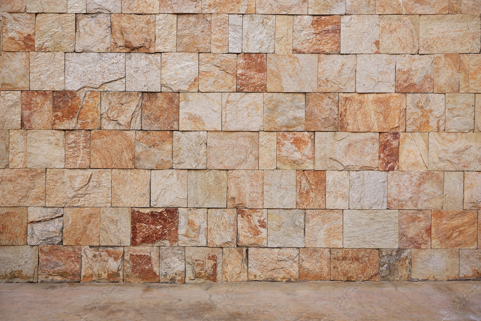 Photo of Beautiful colorful tiled stone wall and floor outdoors