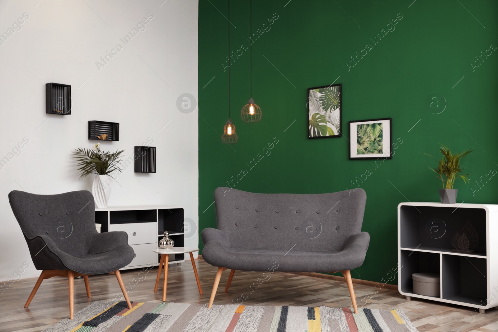 Photo of Modern living room interior stylish sofa near green wall