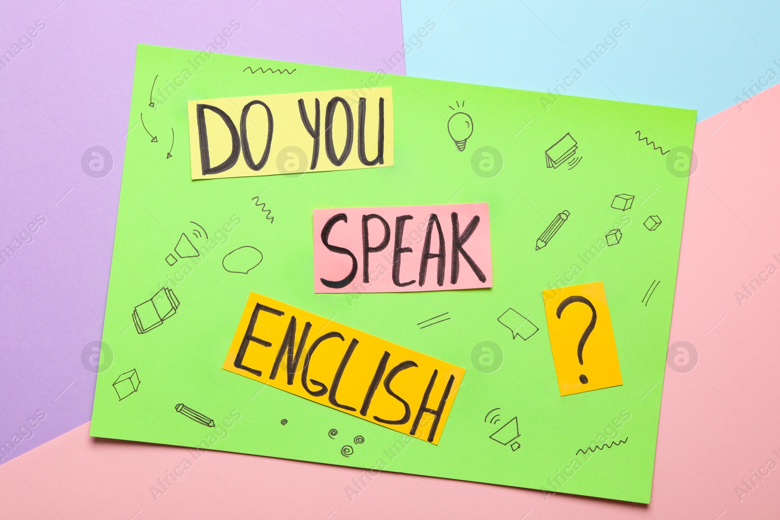 Photo of Note with question Do You Speak English on color background, top view