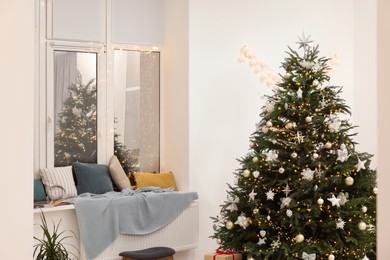 Photo of Beautiful Christmas tree and decor in room. Interior design
