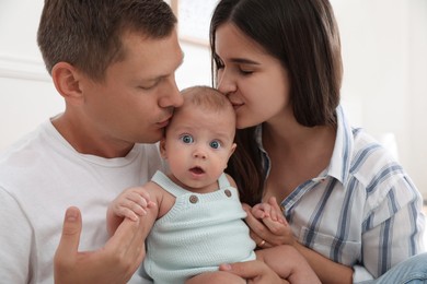 Photo of Happy family with their cute baby at home
