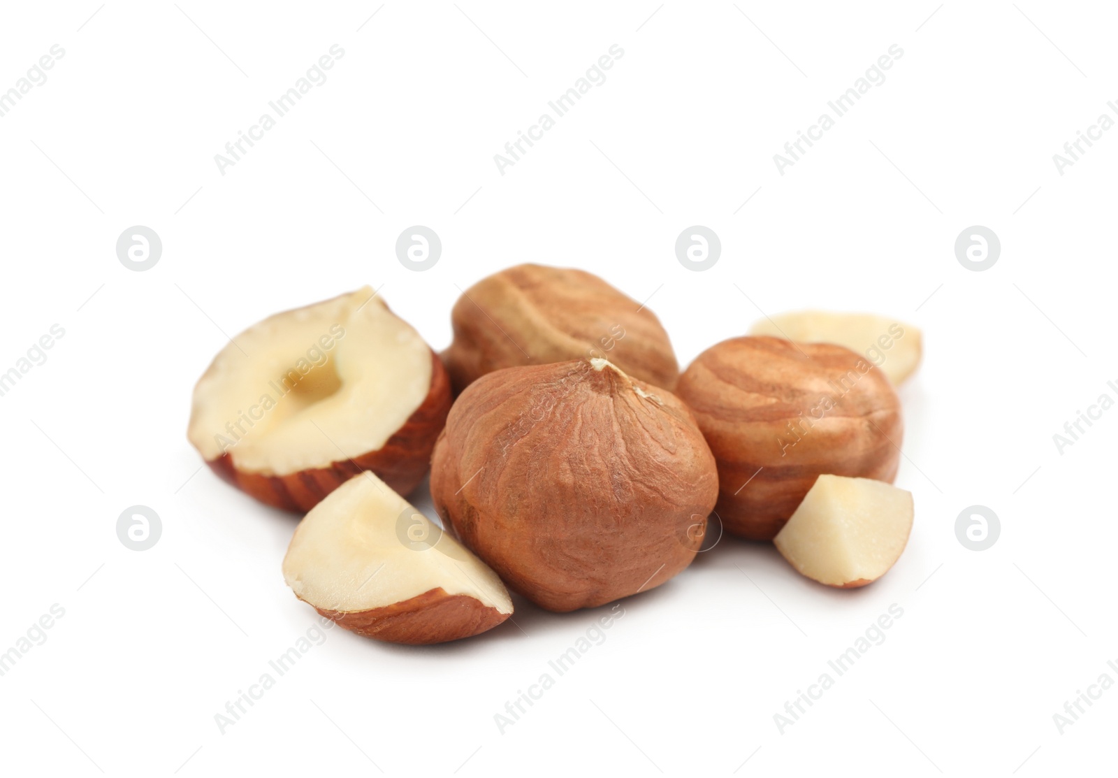 Photo of Heap of tasty hazelnuts on white background