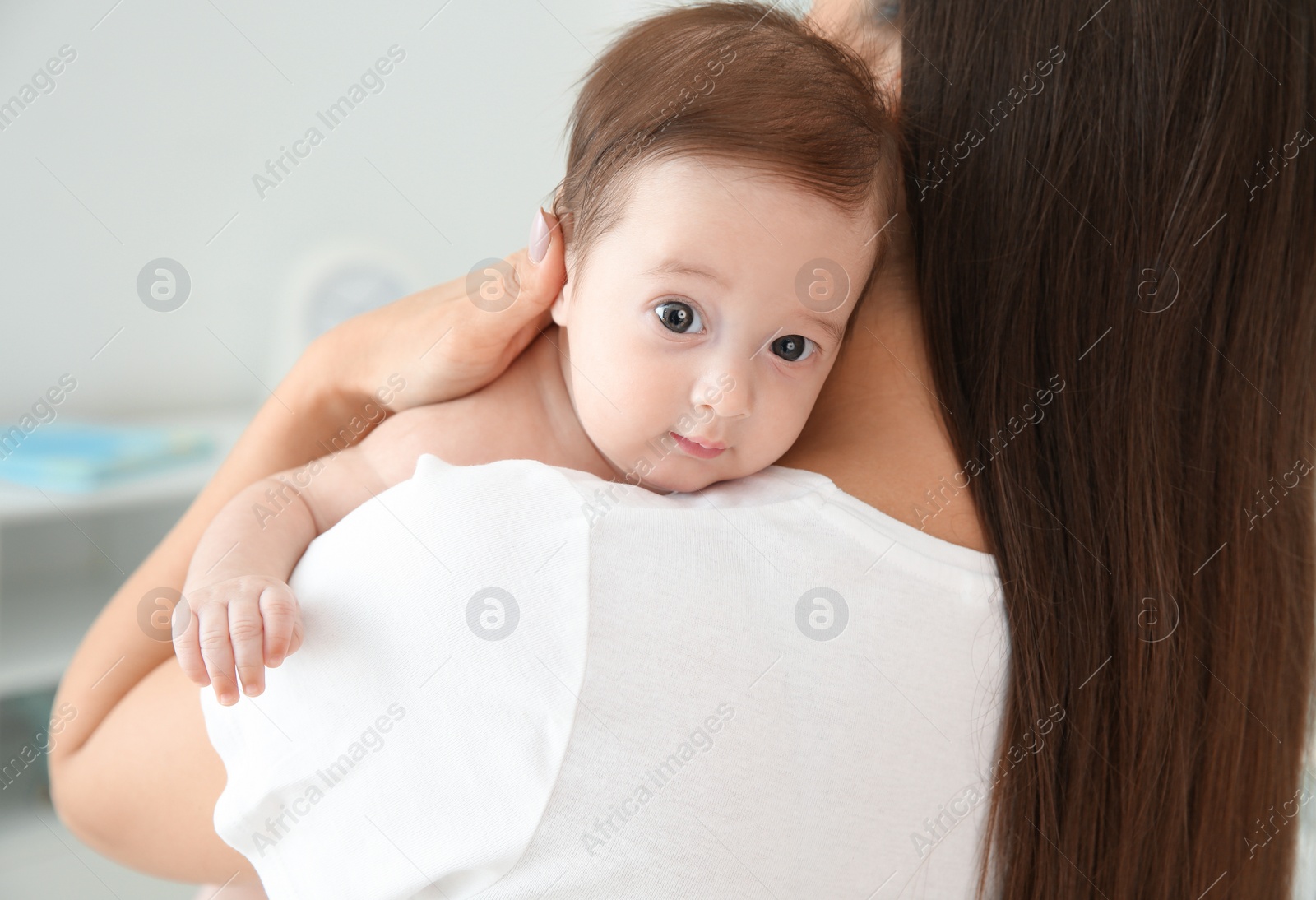 Photo of Woman holding her baby at home, closeup