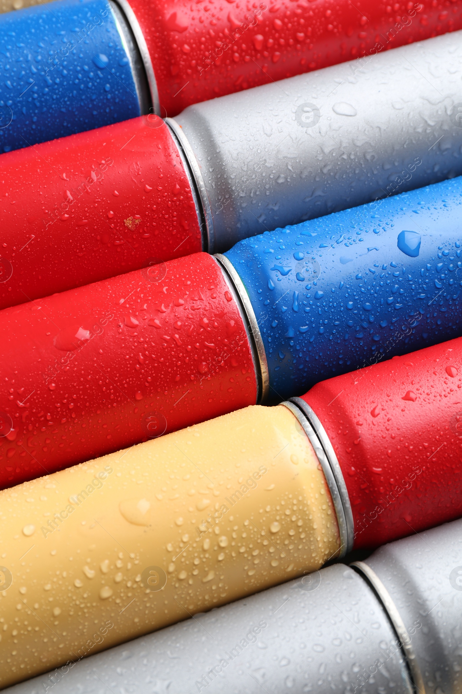 Photo of Energy drinks in wet cans as background, closeup