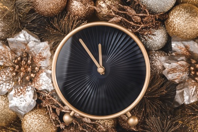 Alarm clock on golden festive decoration, top view. New Year countdown
