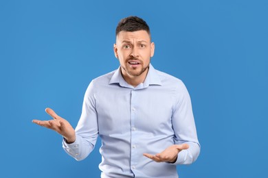 Photo of Emotional man in casual outfit on blue background