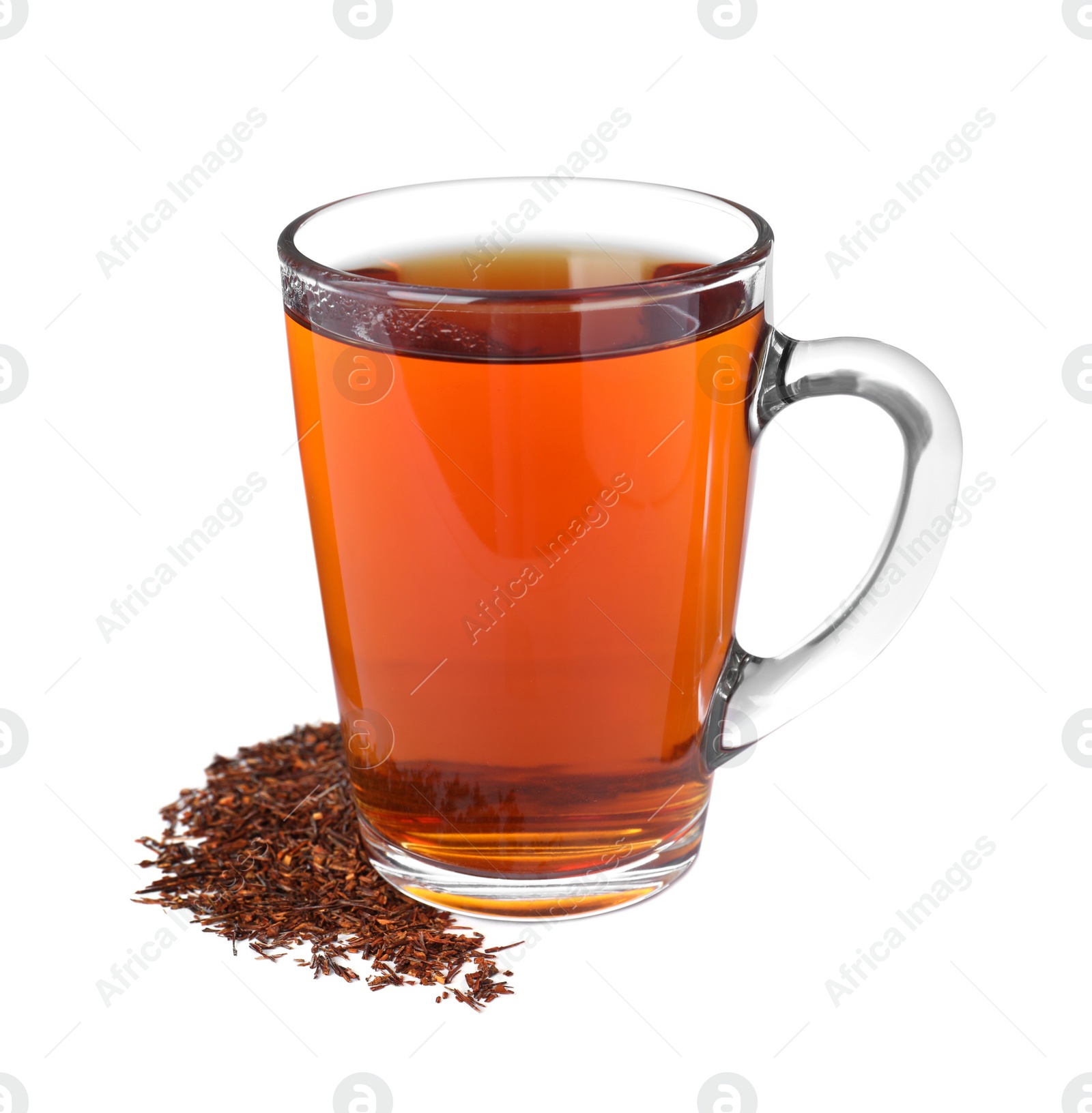 Photo of Aromatic rooibos tea in glass cup and scattered dry leaves on white background