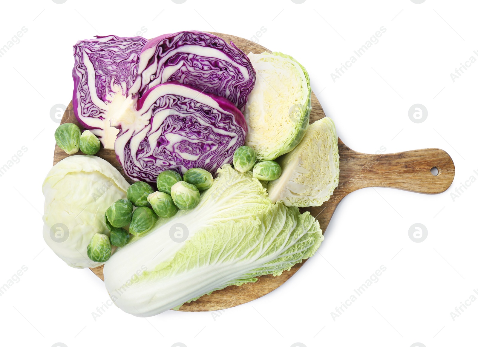 Photo of Wooden board with different types of cabbage isolated on white, top view