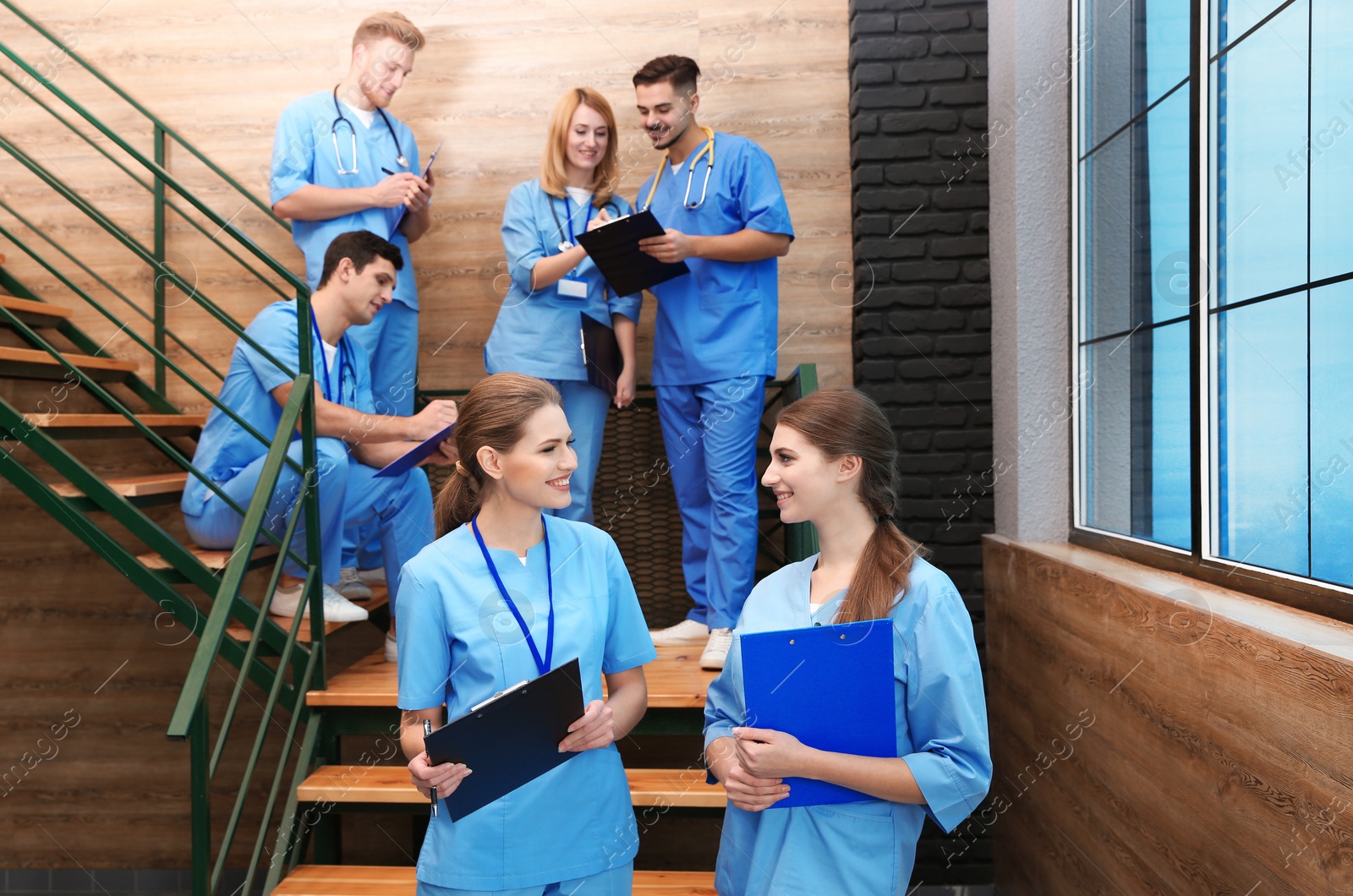 Photo of Young smiling medical students in university hall