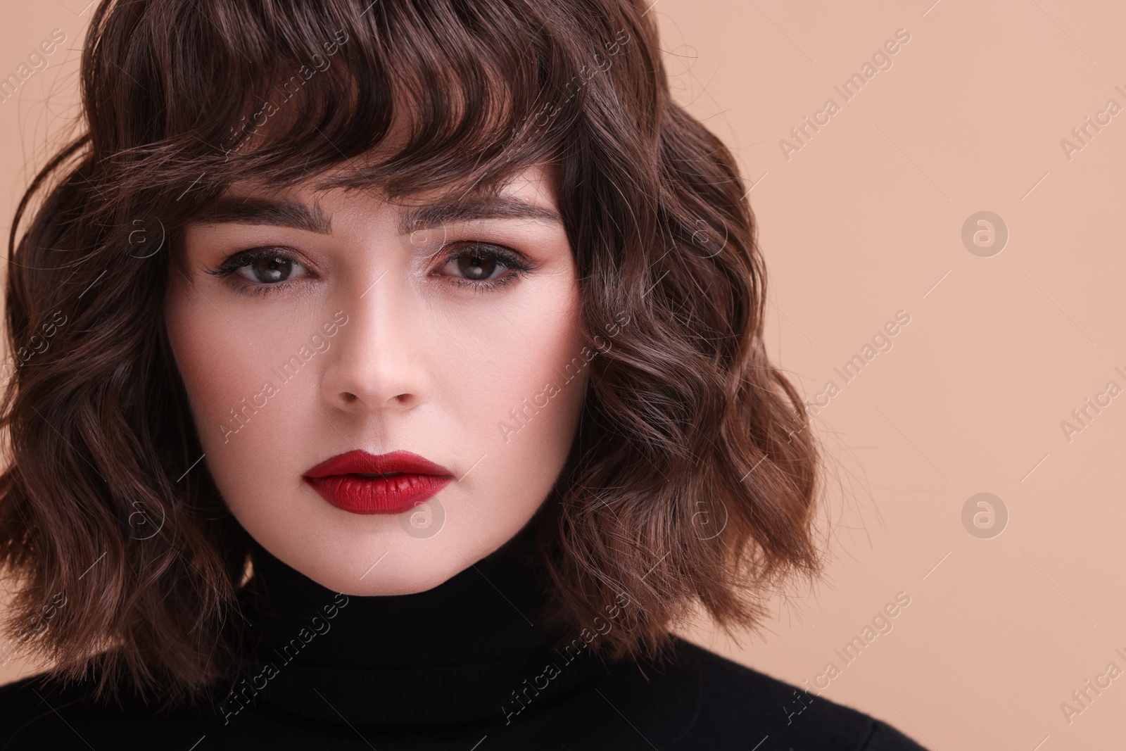 Photo of Beautiful young woman with wavy hairstyle on beige background. Space for text