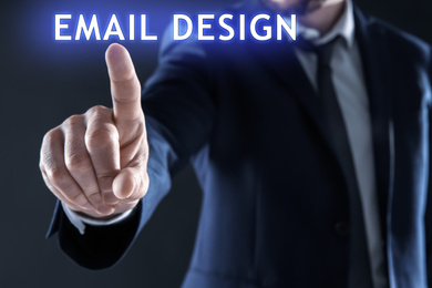 Image of Businessman pointing at phrase EMAIL DESIGN on virtual screen, closeup