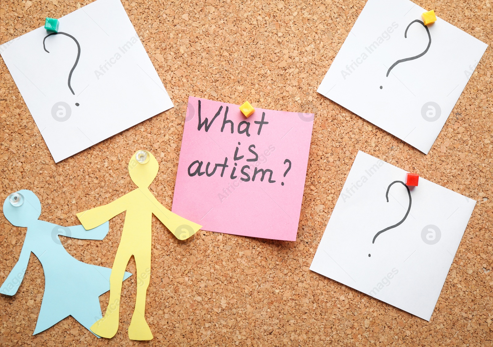 Photo of Sticky note with phrase "What is autism?" on cork background