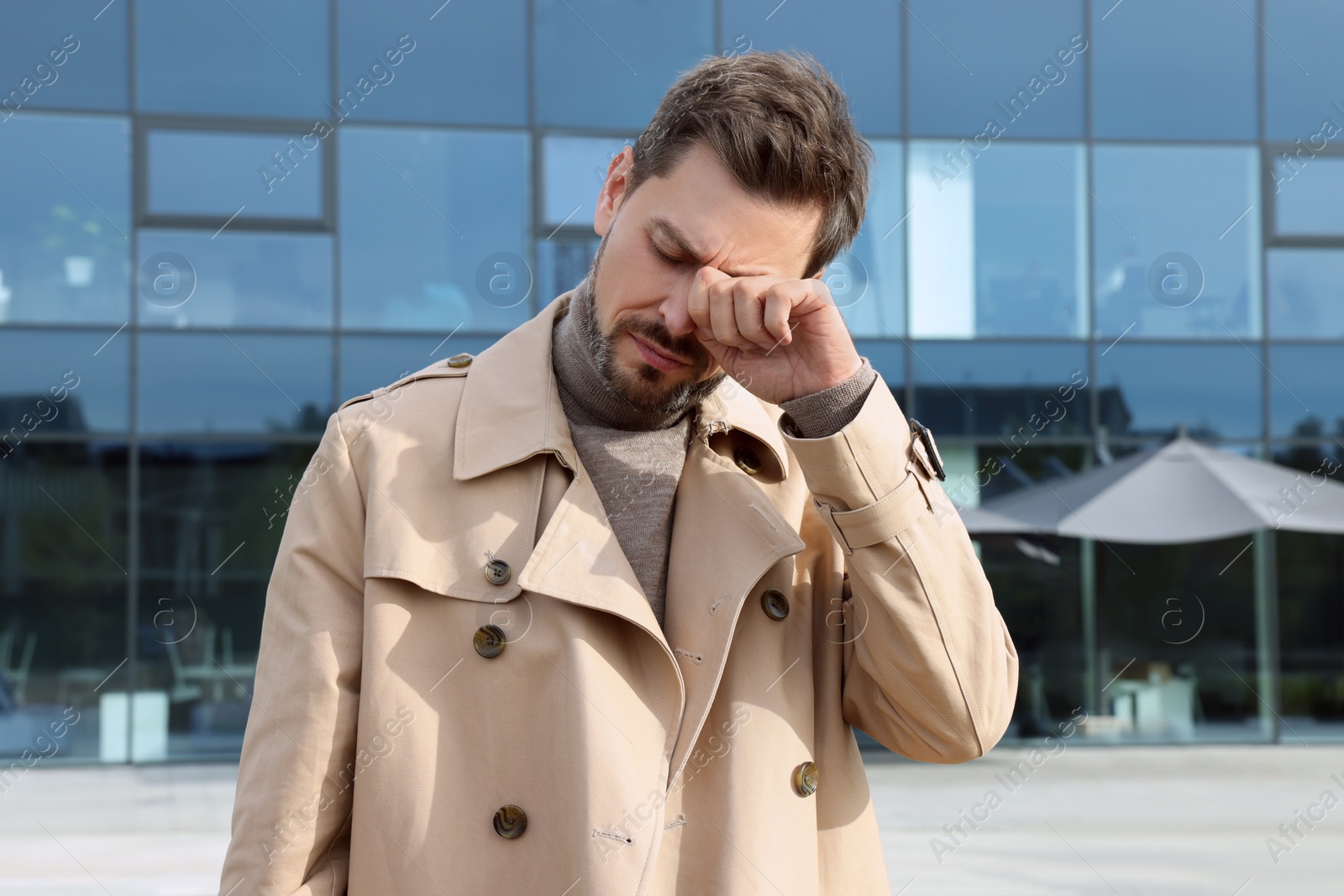 Photo of Sleepy tired man outdoors on sunny day