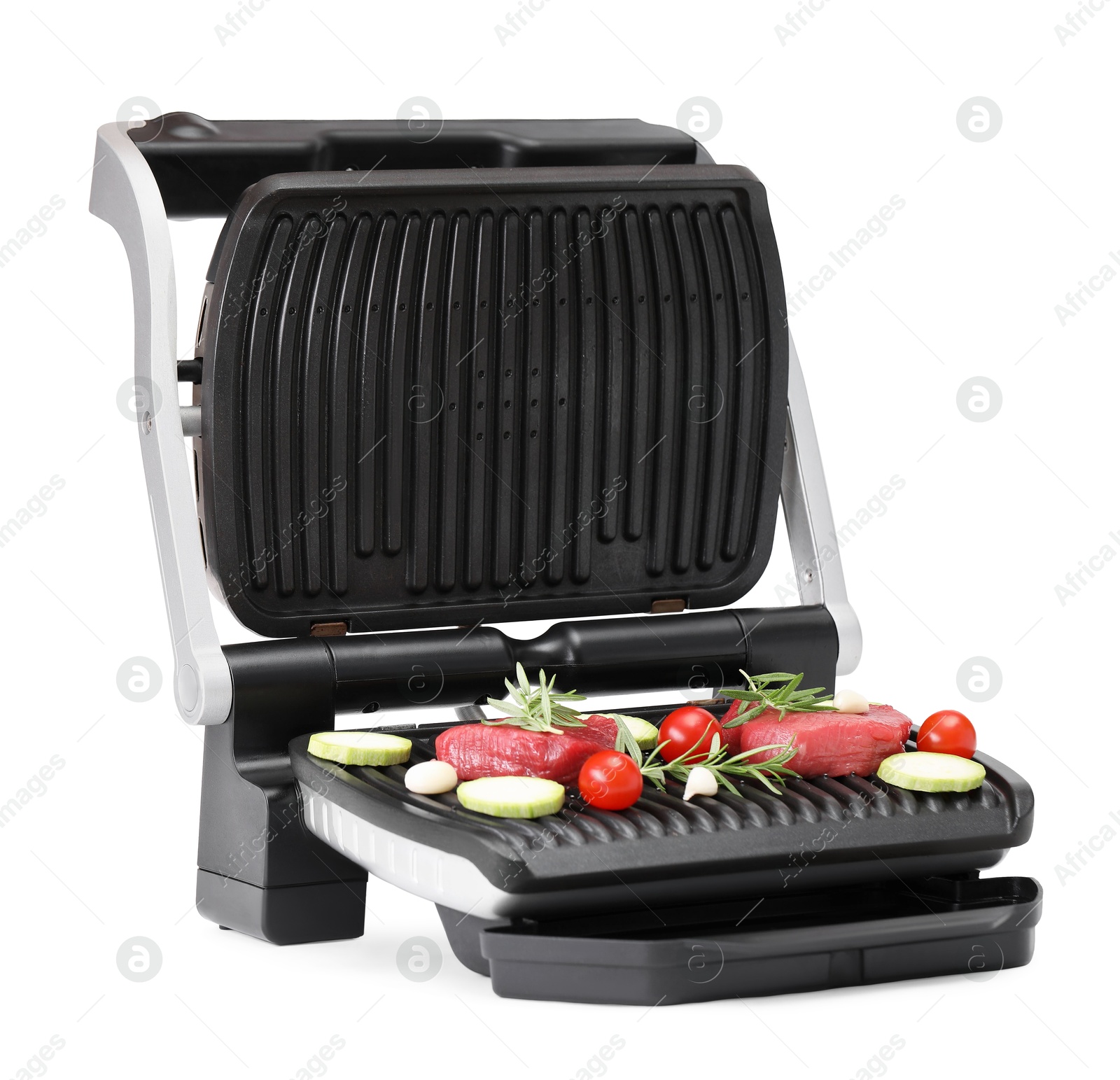 Photo of Electric grill with raw meat, rosemary and vegetables isolated on white